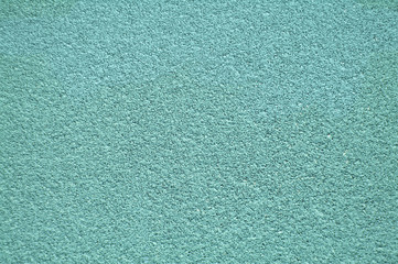 Turquoise horizontal wall covered with plaster texture.
