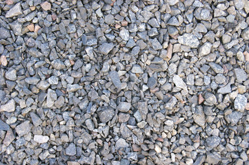 Small road stone background, dark gravel pebbles stone texture seamless texture