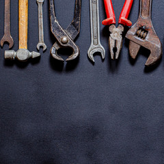 Tools for repair and reconstruction in home conditions lie on a black background