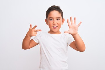 Beautiful kid boy wearing casual t-shirt standing over isolated white background showing and pointing up with fingers number eight while smiling confident and happy.