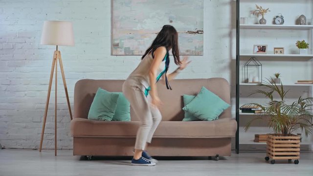 happy woman dancing in living room