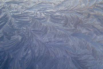 Beautiful frosty pattern an equal surface in winter morning.
