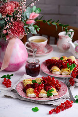 Crepes with lemon cream and raspberry jam. .selective focus.