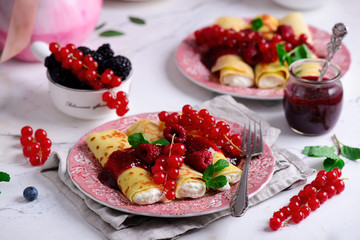 Crepes with lemon cream and raspberry jam. .selective focus.