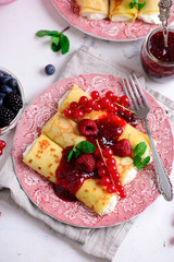 Crepes with lemon cream and raspberry jam. .selective focus.