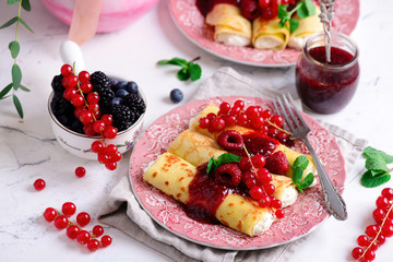 Crepes with lemon cream and raspberry jam. .selective focus.
