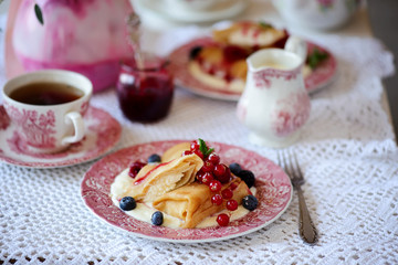Crepes with lemon cream and raspberry jam. .selective focus.