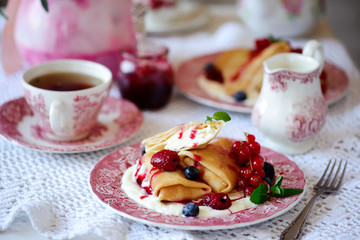 Crepes with lemon cream and raspberry jam. .selective focus.