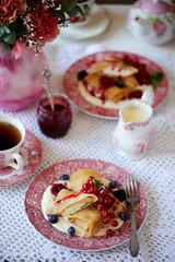 Crepes with lemon cream and raspberry jam. .selective focus.