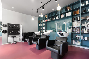 Bright interior of a beauty salon with armchairs for hairdresser procedures - obrazy, fototapety, plakaty