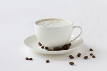 White coffee cup with plate and cofee beans isolated on white.