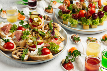 portioned snacks canapes and sandwiches with meat, cheese and vegetables