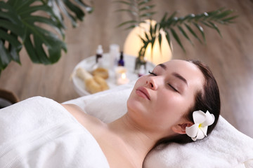 Obraz na płótnie Canvas Portrait young beautiful woman lying on the massage table in spa wellness salon. Beauty and health procedures for women concept. Close up, copy space, background.