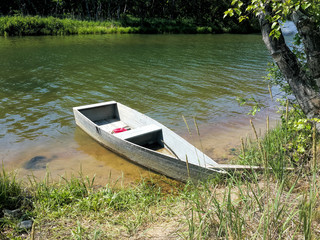 Old wooden boat on the lake in spring