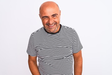 Middle age handsome man wearing striped navy t-shirt over isolated white background winking looking at the camera with sexy expression, cheerful and happy face.