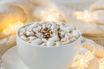 Christmas or New Year background with white cup of hot cocoa with marshmallows.