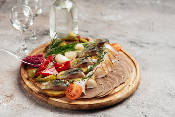 traditional vodka appetizer with herring and beef tongue