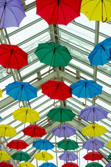 Fototapeta na wymiar Colourful Umbrellas As Decoration In The Air With Glass Ceiling Celebration and Decoration