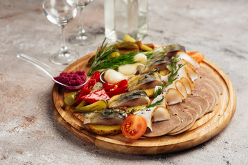 traditional vodka appetizer with herring and beef tongue