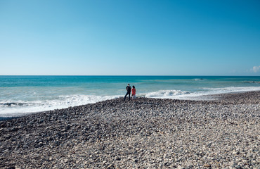 A couple of tourists on the seashore.