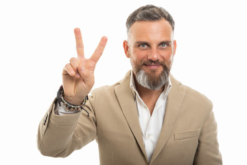 Portrait of handsome man wearing smart casual clothes showing peace