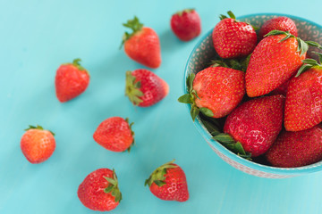 strawberries in a colorful bowl on a colorful background