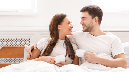 Loving Boyfriend And Girlfriend Having Coffee Lying In Bed, Panorama