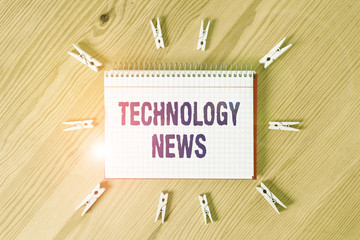 Handwriting text writing Technology News. Conceptual photo newly received or noteworthy information about technology Colored clothespin papers empty reminder wooden floor background office