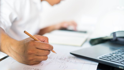 Fototapeta premium Structural design engineers work in building structure analysis.Closeup video Insturments and office for designer.drawings and computer on the table.Heavy industry business Concept Construction