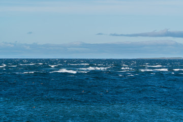 Dark deep blue sea with small breaking waves