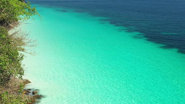 Aerial view of ocean waves, Beautiful tropical beach and rocky coastline and beautiful forest. Nyaung Oo Phee Island Myanmar