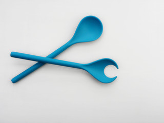 blue bamboo spoons for salad on a white background.