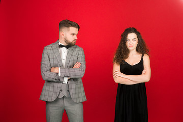 Upset couple in formal wear has conflict in holiday