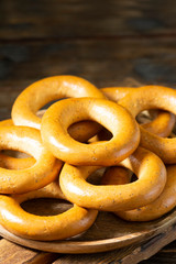 Bagels on a wooden plate on a brown wooden table. Rustic style. Homemade cake