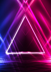 Dark abstract futuristic background. The geometric shape of a triangle in the middle of the scene. Neon blue-pink rays of light on a dark background