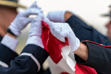 Soldiers fold an American Flag at a funeral for a Fallen Hero