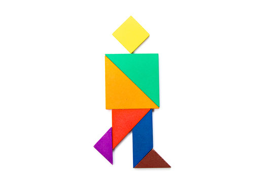 Color wood tangram puzzle in walking man shape on white background