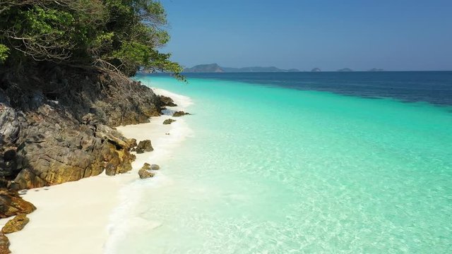 Aerial view of ocean waves, Beautiful tropical beach and rocky coastline and beautiful forest. Nyaung Oo Phee Island Myanmar