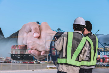 two worker planing with hand check in portimport, foreman control loading Container box from cargo...