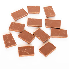 Milk chocolate pieces isolated on white background from top side view