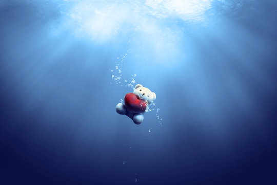 teddy bear toy sinking in the sea background in vision and idea conceptual image