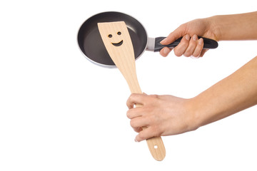 a pan in hands on a white background