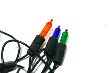 Multi-colored blinking light bulbs with coiled cables placed on a white background
