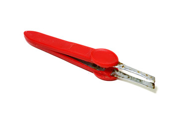 Old red tweezers placed on a white background