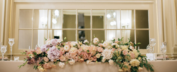 Beautiful table decoration in the restaurant with fresh roses