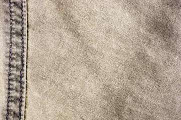 clothing items stonewashed cotton fabric texture with seams, clasps, buttons and rivets, macro