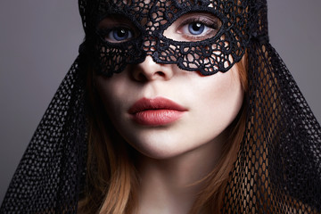 Beautiful young Woman in a Carnival Mask