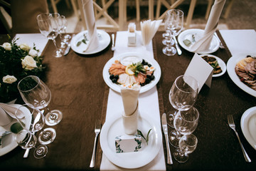 Elegant table set for dinner with food.  Catering service