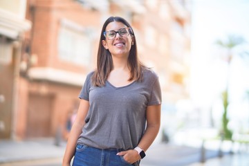 Young beautiful woman smiling happy and confident. Standing with smile on face at town street