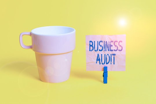 Text sign showing Business Audit. Business photo showcasing examination of the financial report of an organisation Cup empty paper blue clothespin rectangle shaped reminder yellow office